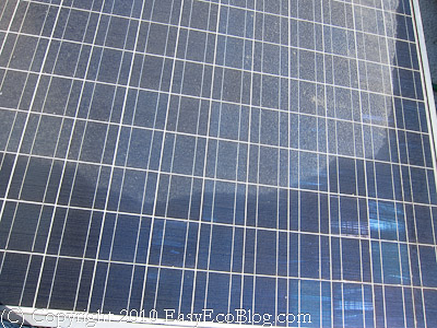 dirty solar panel, partially clean solar panel